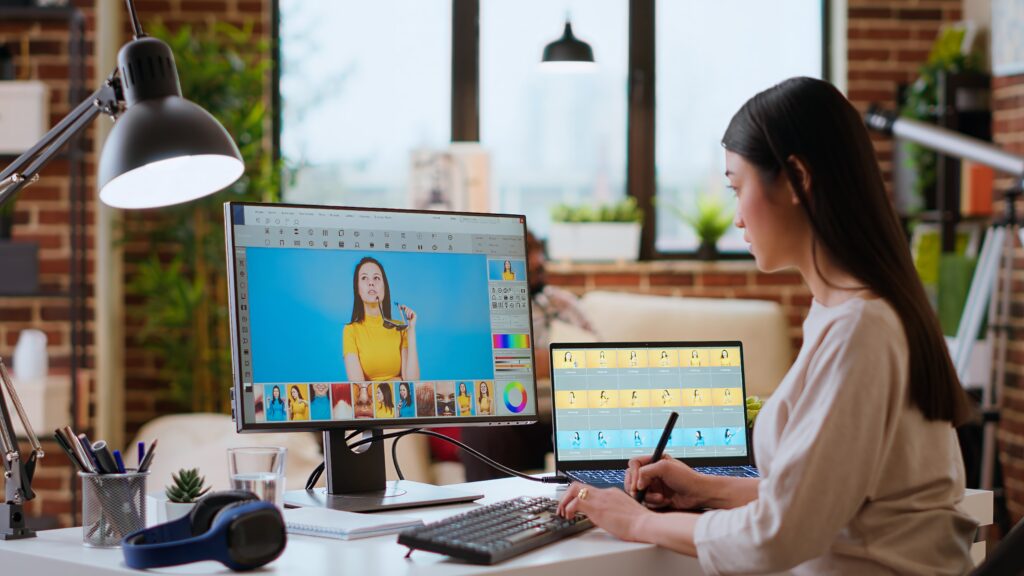 asian graphic designer uses editing software for photo retouching
